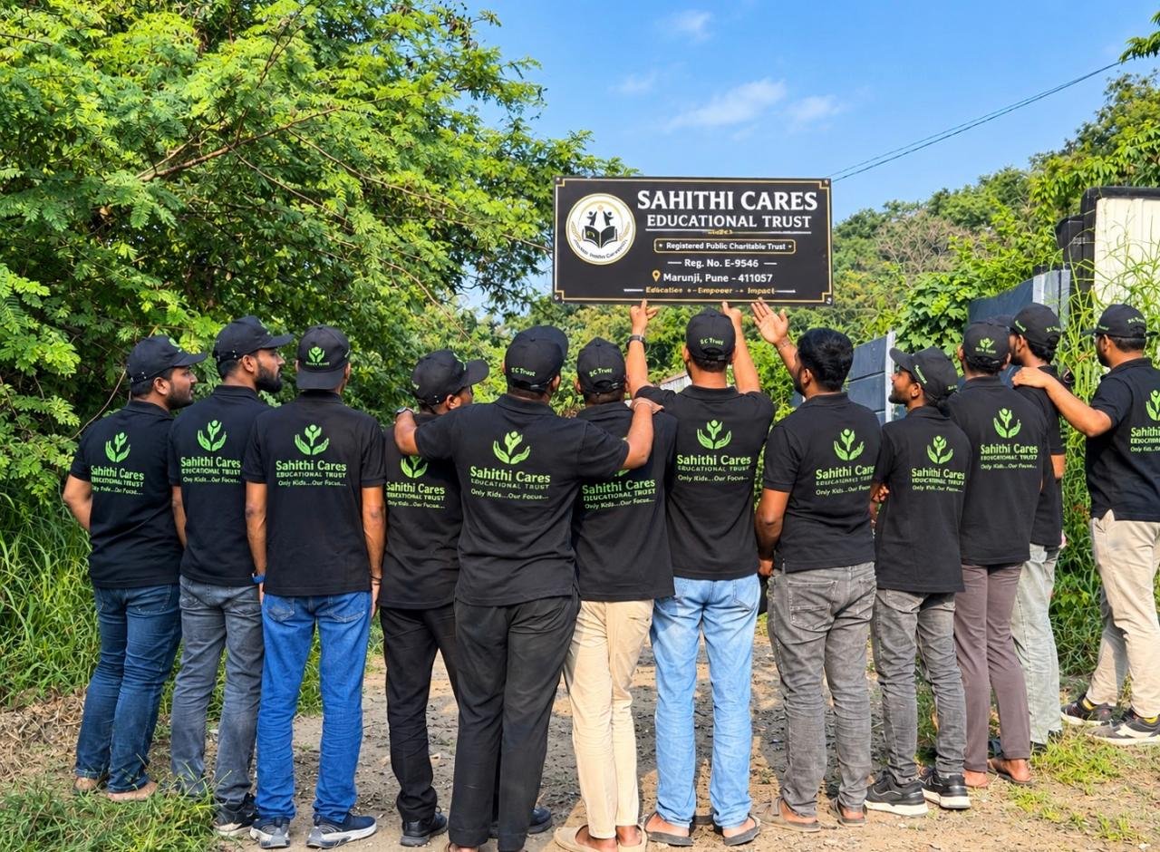 Sahithi Cares volunteers unveiling the trust name board at a plantation drive